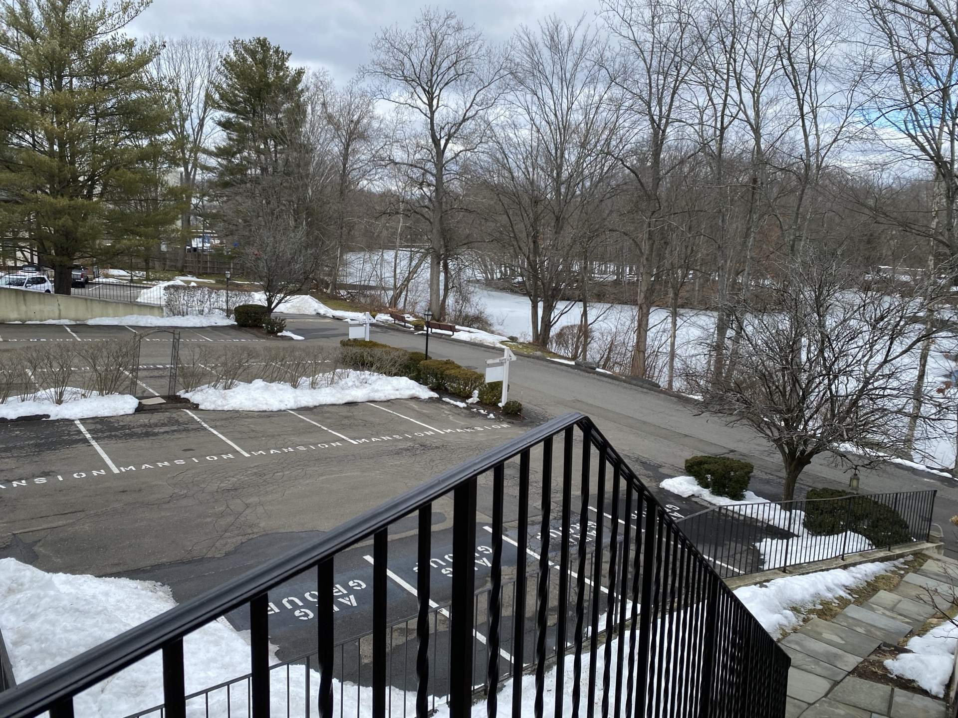 Winter view from the mansion's balcony overlooking parking and grounds along the Noroton River