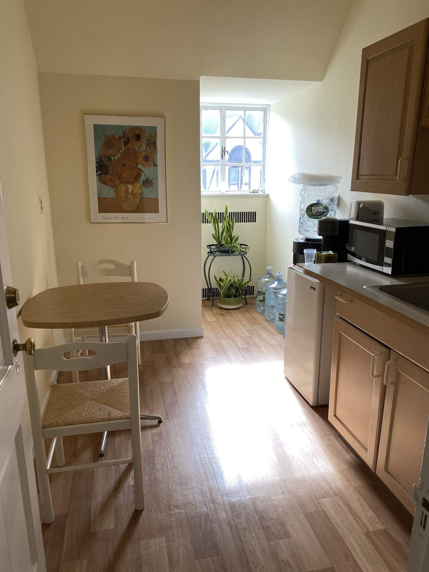 Kitchen area with Tudor window and sunflower print at The Phillips Mansion