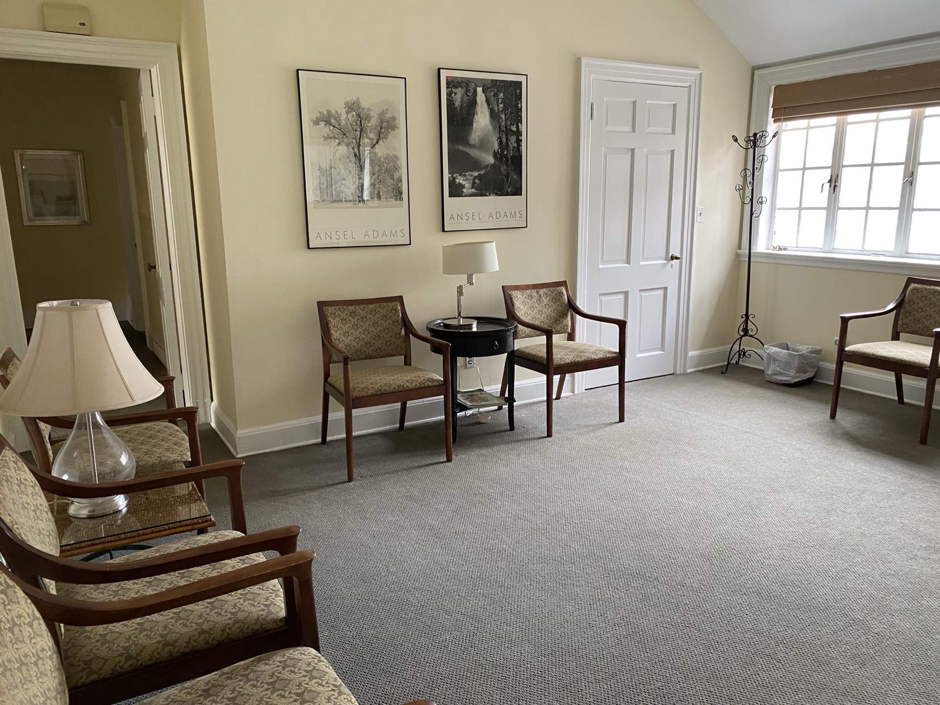 Sitting room with curated art and natural light at The Phillips Mansion